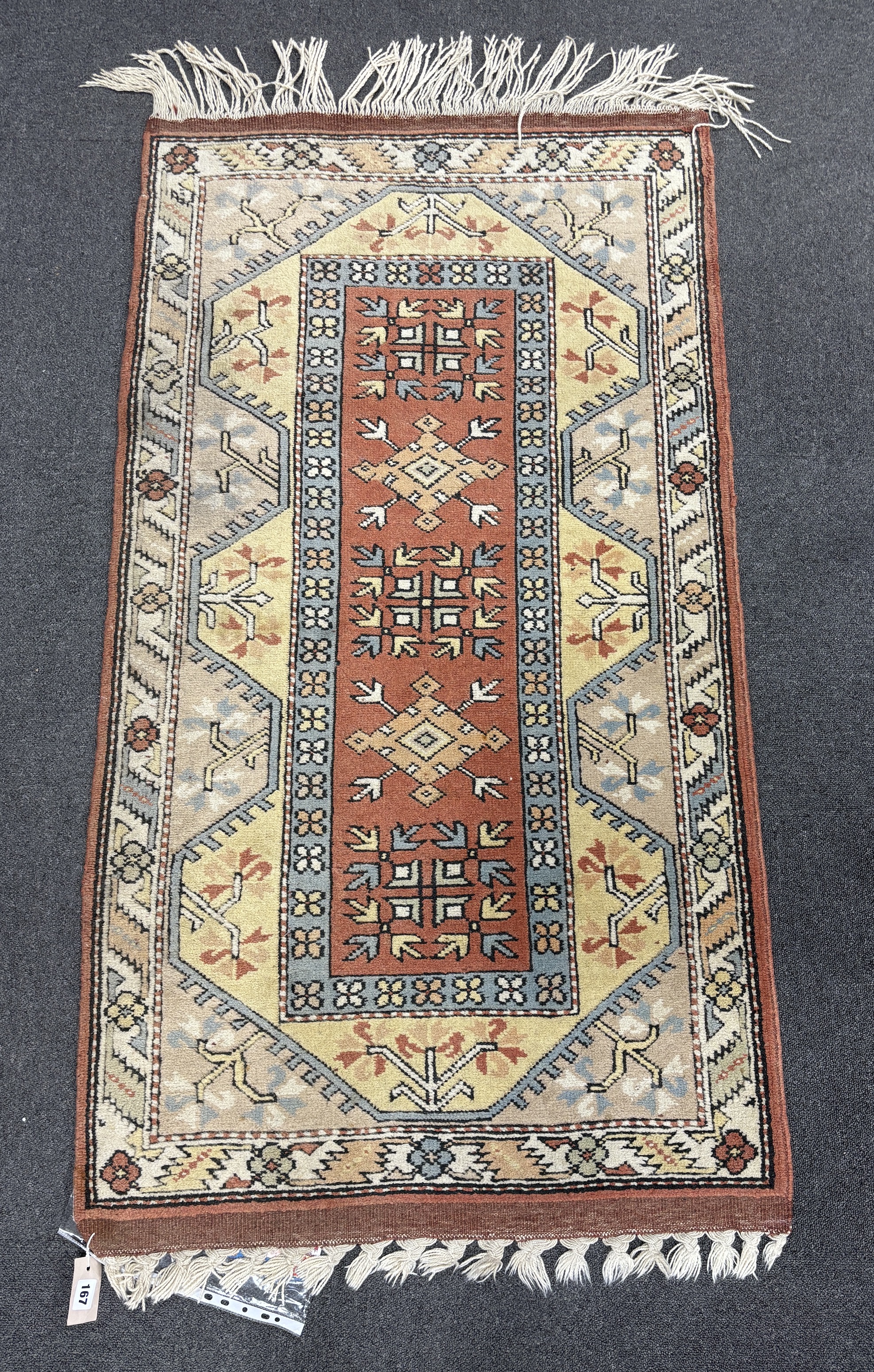 A Turkish geometric rug, 154 x 84cm with purchase receipt.